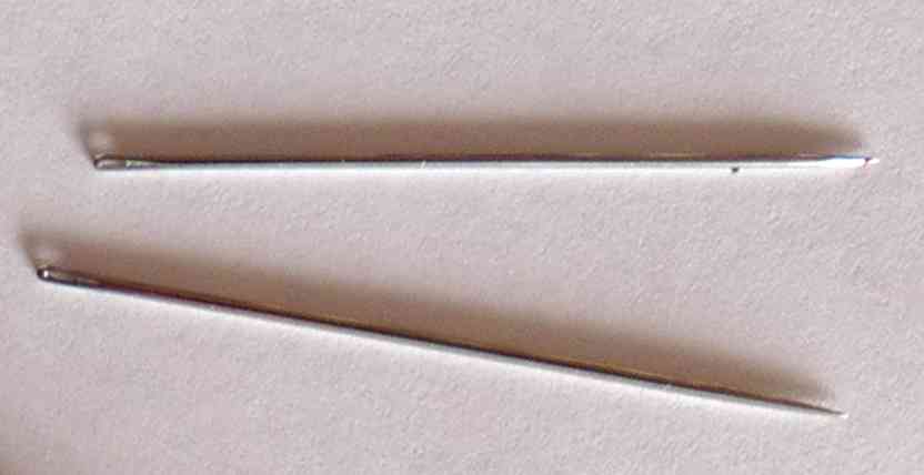 Two sewing needles extracted from the card